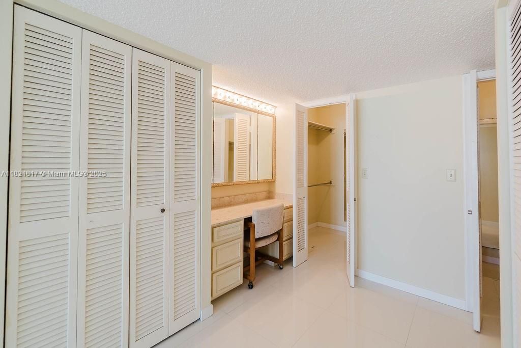 Spacious bedroom with walk-in closet and ensuite bath — comfortable and modern Miami Beach living.