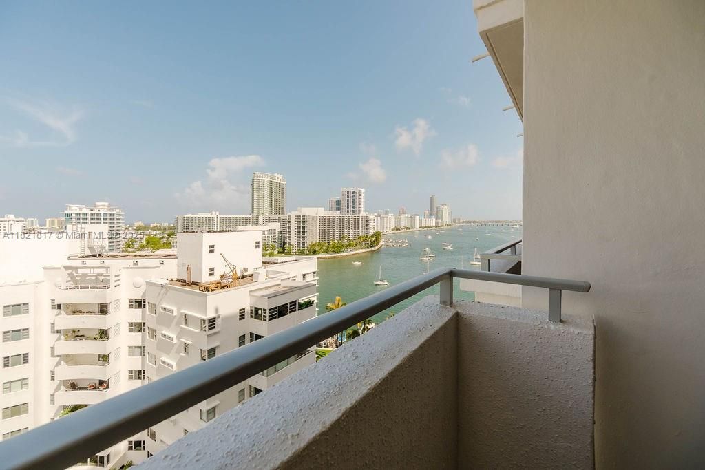 Expansive balcony with panoramic water and city views, offering the best of Miami Beach indoor-outdoor lifestyle.