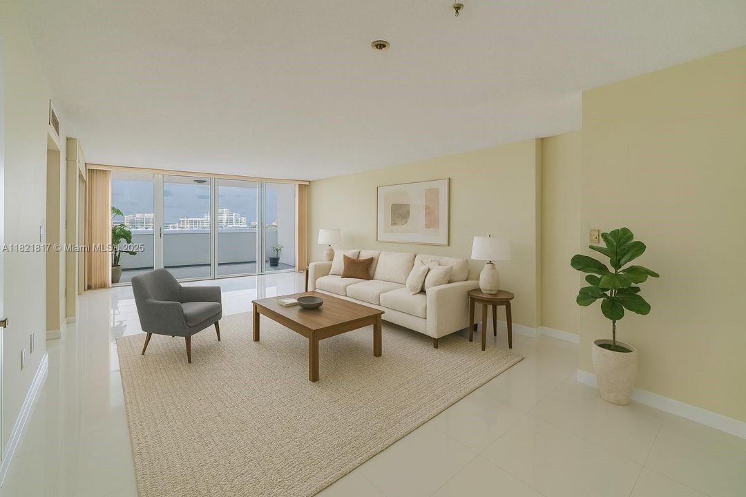 Spacious open-concept living room with floor-to-ceiling windows, filled with natural light and stunning bay views — ideal Miami Beach condo living.