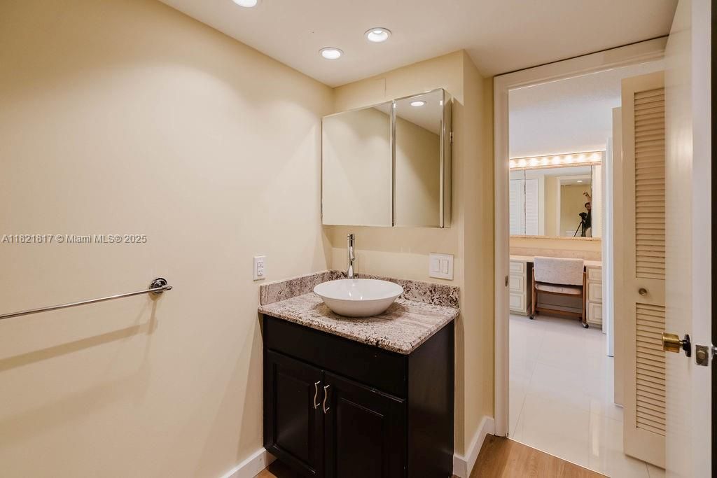 Bright and airy primary bedroom with private balcony access and water views — perfect for sunrise mornings.