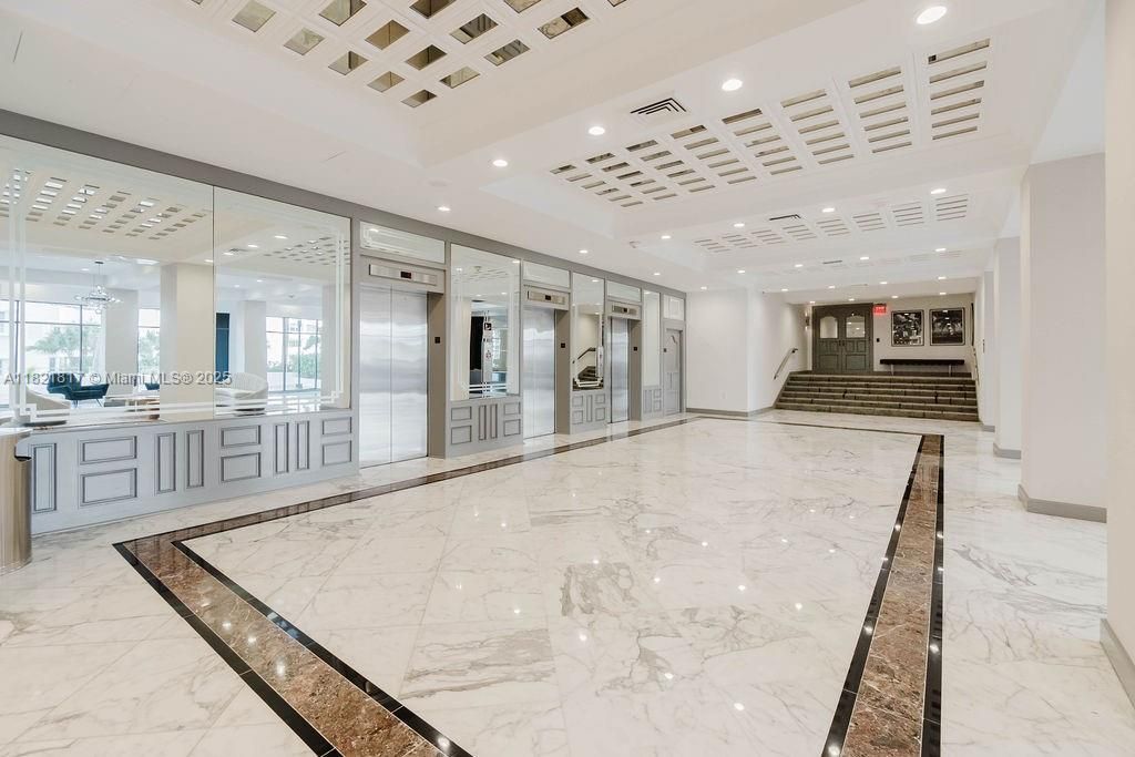 Elegant lobby with modern design and seating area — welcoming ambiance with 24-hour concierge service.