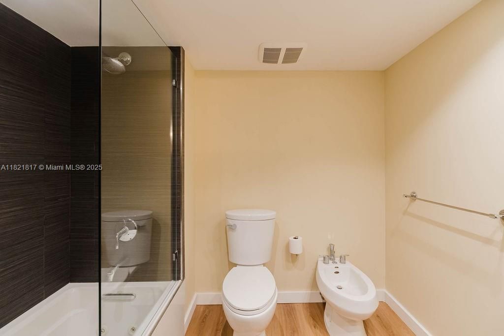 Renovated primary bathroom featuring double sinks, walk-in shower, and premium finishes — spa-style comfort in your condo.