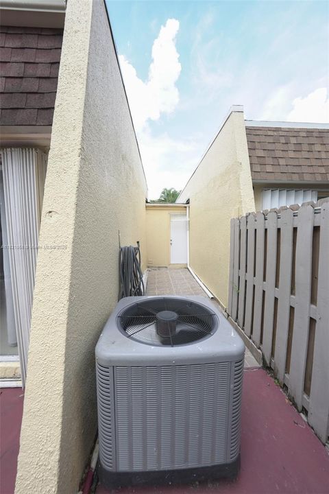 Side of house where you can enter into the garage through the back patio