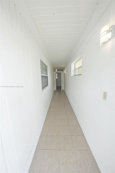 This is what you see when you enter main outside door.  Hallway with entrance to garage on the left and a door to enter the foyer area before you enter the house.