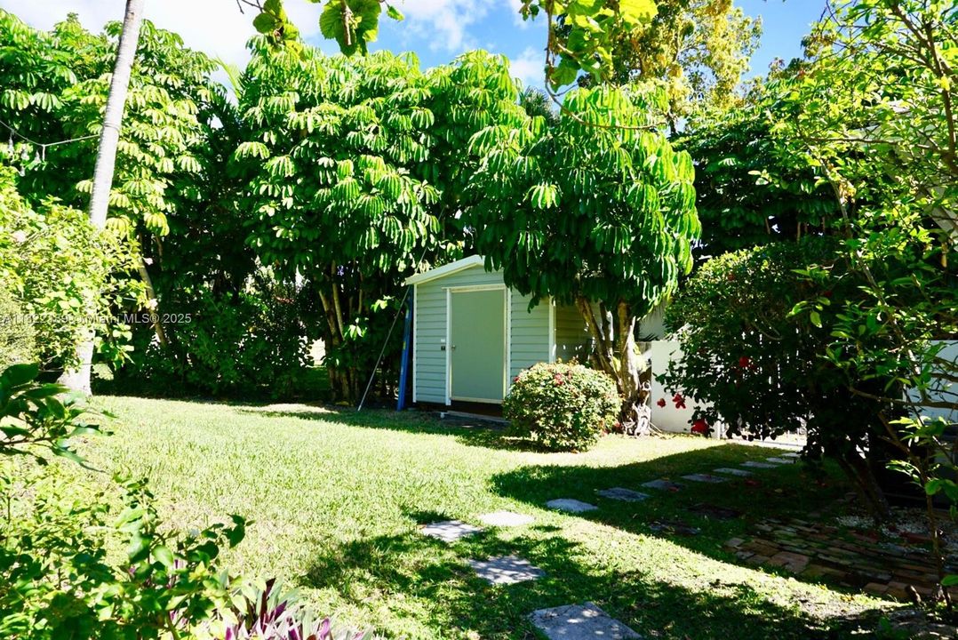 Storage shed in backyard house also has a 2 car garage