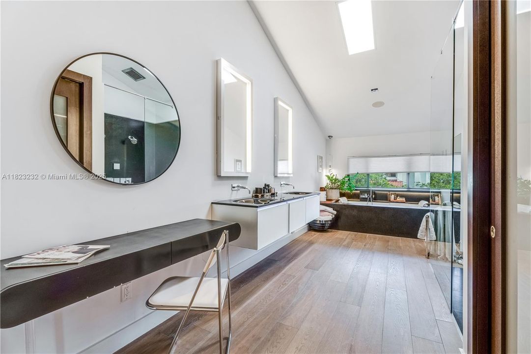Generous primary bathroom featuring a Jacuzzi tub with separate shower.