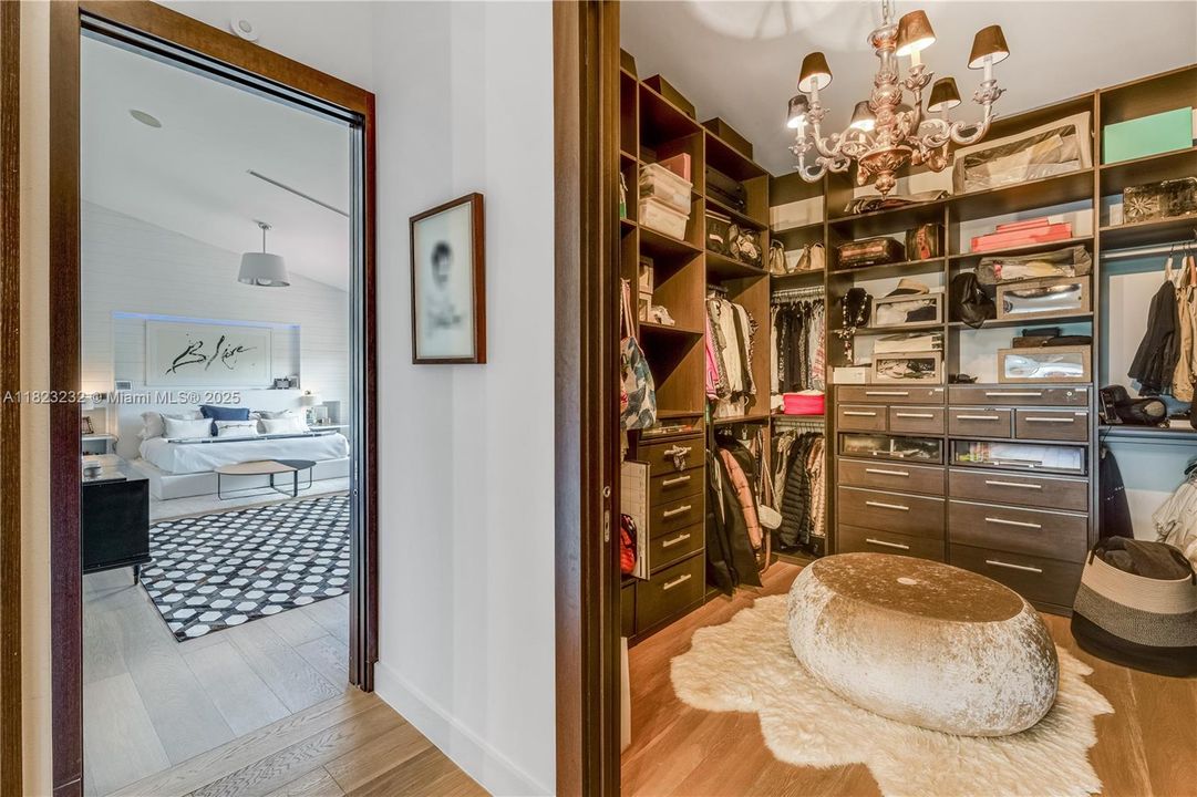 Luxurious primary suite featuring a spacious walk-in closet and elegant en-suite bathroom.