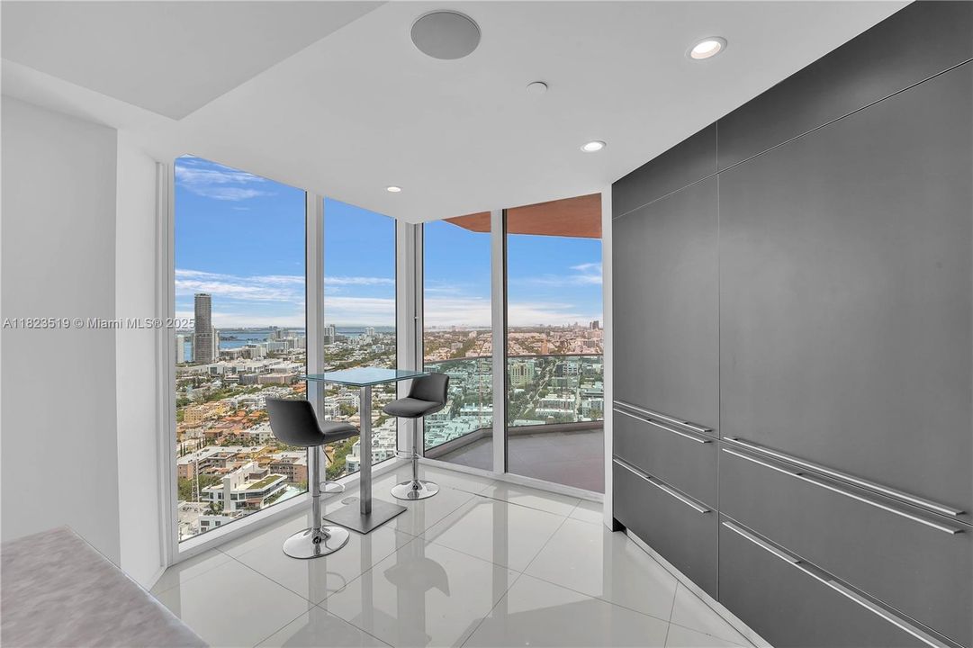 Breakfast Nook for two additional persons next to long counter and adjacent to balcony.  Table can be set up just outside on balcony for outdoor dining or wine while enjoying views!