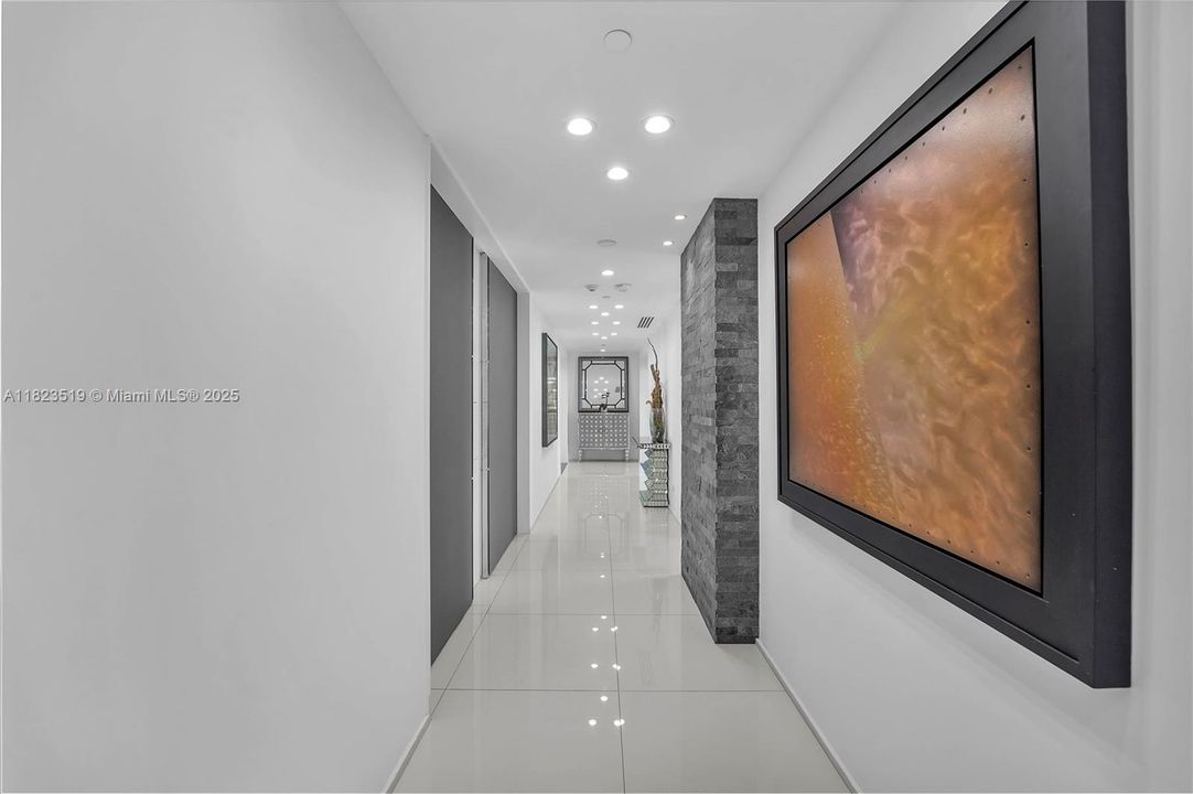 40' Long art entry foyer from two locked elevators towards the left with covering panels in shut position shown.