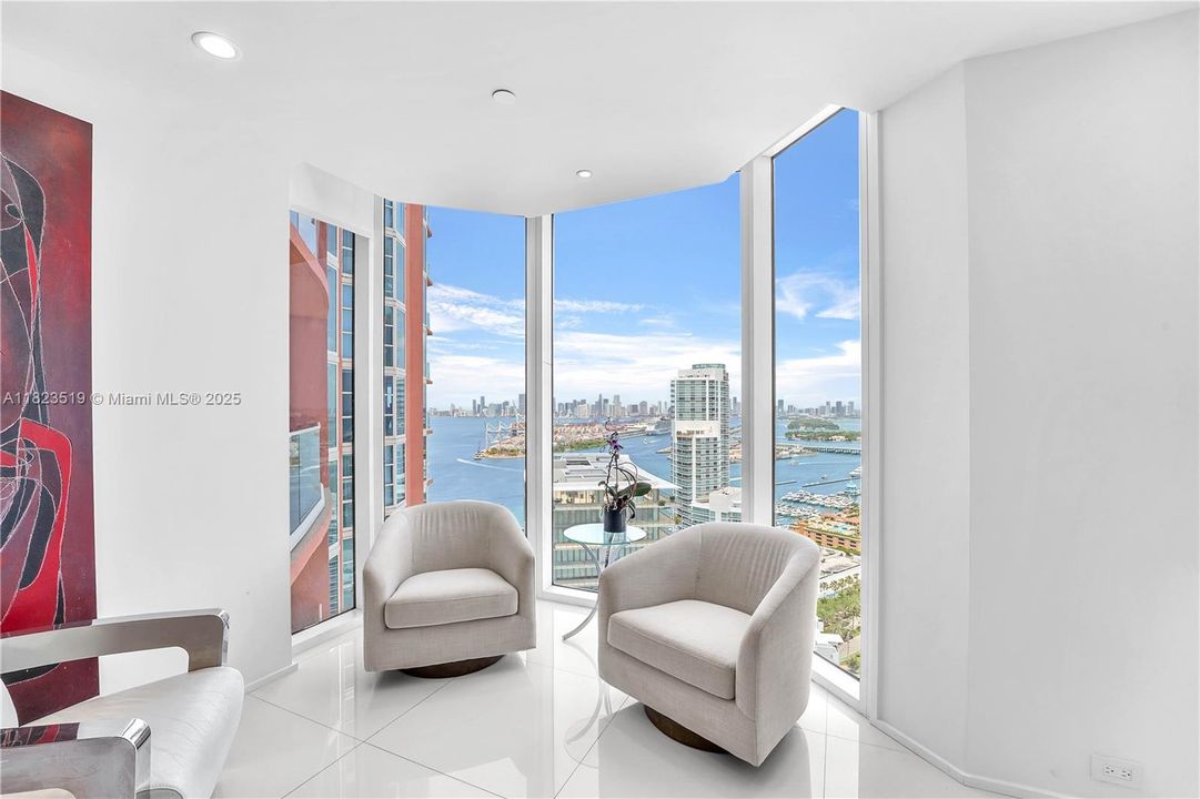 Sitting area can accommodate love seat and chairs or wrap around custom sofa. View above Apogee to shipping lanes and Port of Miami is shown.