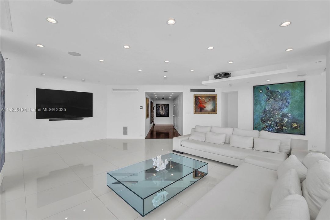 Turns into a theatre with projector or plasma TV.  Recessed projector, screen, and speakers. Sofas can be reconfigured into two rows.