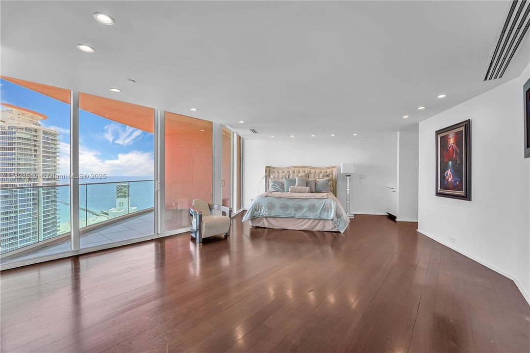 Master Bedroom dimensions approx. 23 x 17.  walk in closet toward right.  Private balcony facing east towards beach, South Pointe Park and Continuum.  concealed fridge in corner.