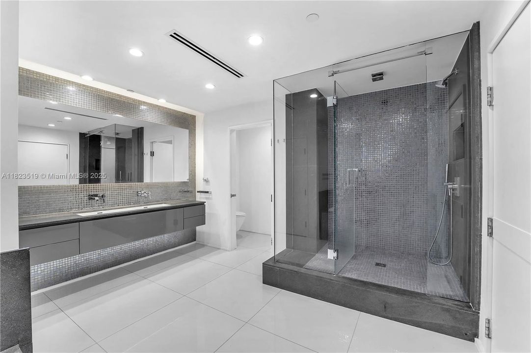 Second Master bathroom with dual sinks, large tub and shower.