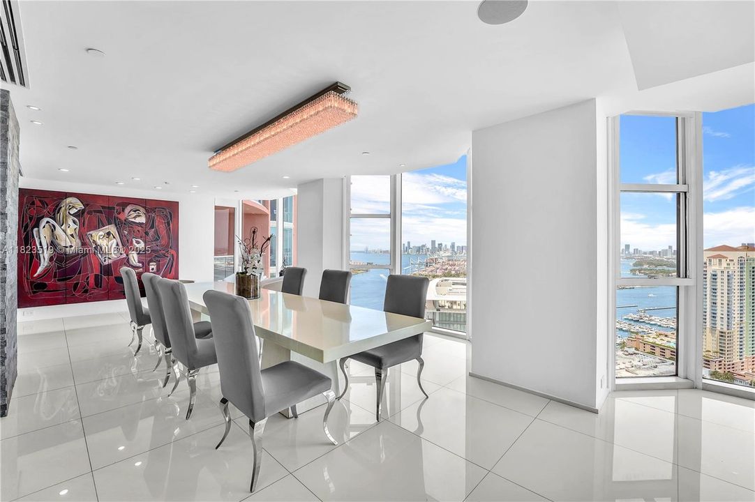 Massive dining Room flows straight from kitchen area:  dimensions 15' long x 12-15' wide.  Pictured 13' dining table has seating for 12+ persons. Beautiful Western views of intracoastal and Miami Skyline.