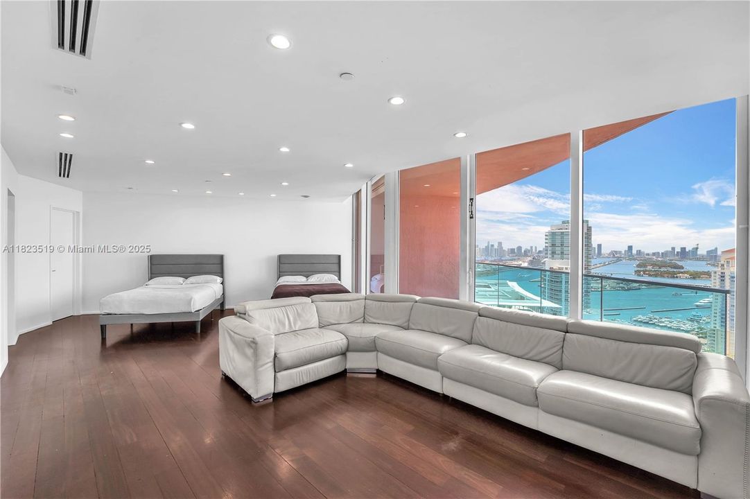 Dual Master bedroom converted into sofa play area for children.  Adjacent are balcony #4, large walk in closet and large second master bathroom.