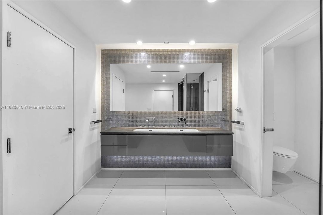 Second dual master bathroom with extra storage closet.