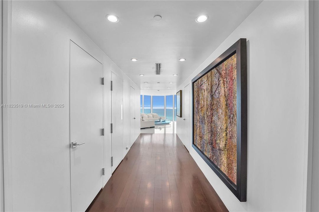 25' Hallway adjoining Great Room.  Doors to left house walk in pantry; walk in washer dryer room; and one of two AC closets.