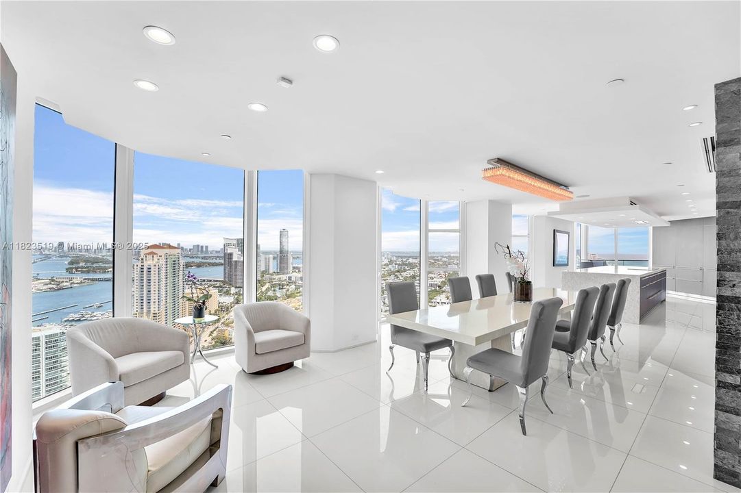 Additional 8' long seating area can extend 15' long dining room if needed for holidays. Multiple bay windows. Crystal chandelier. 34th Story views are above the nearby Apogee.