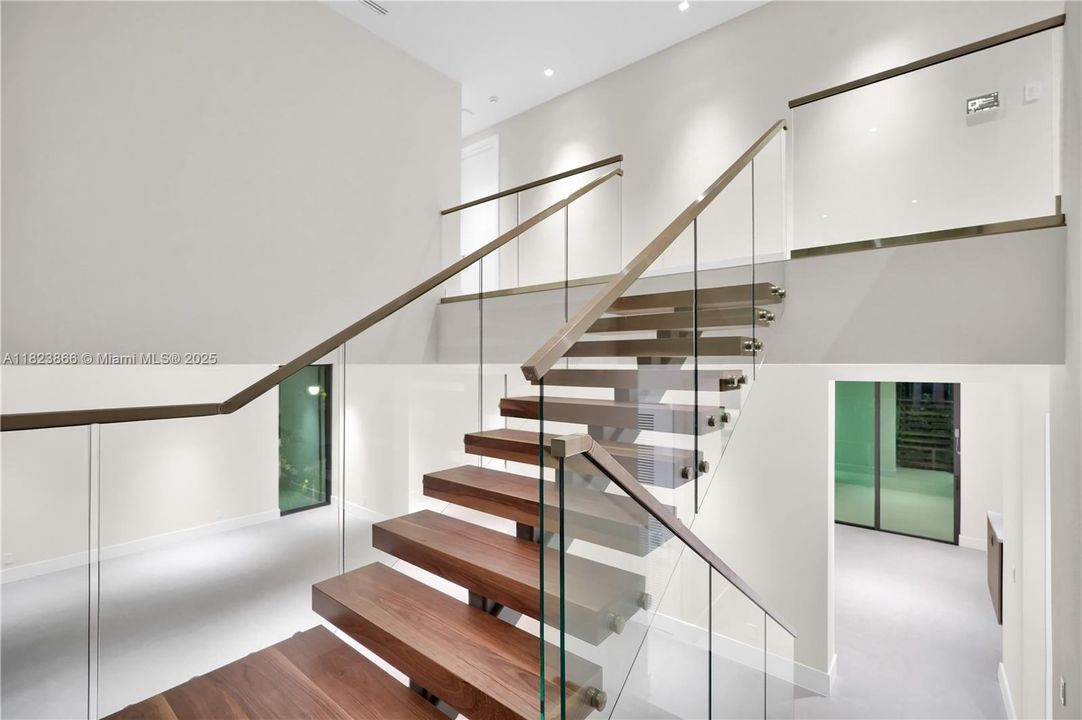 Walnut Staircase leading to upper level