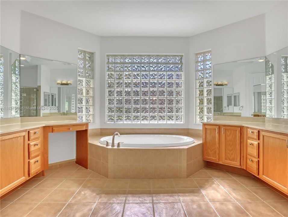 ensuite bathroom with jacuzzi tub and shower, WC