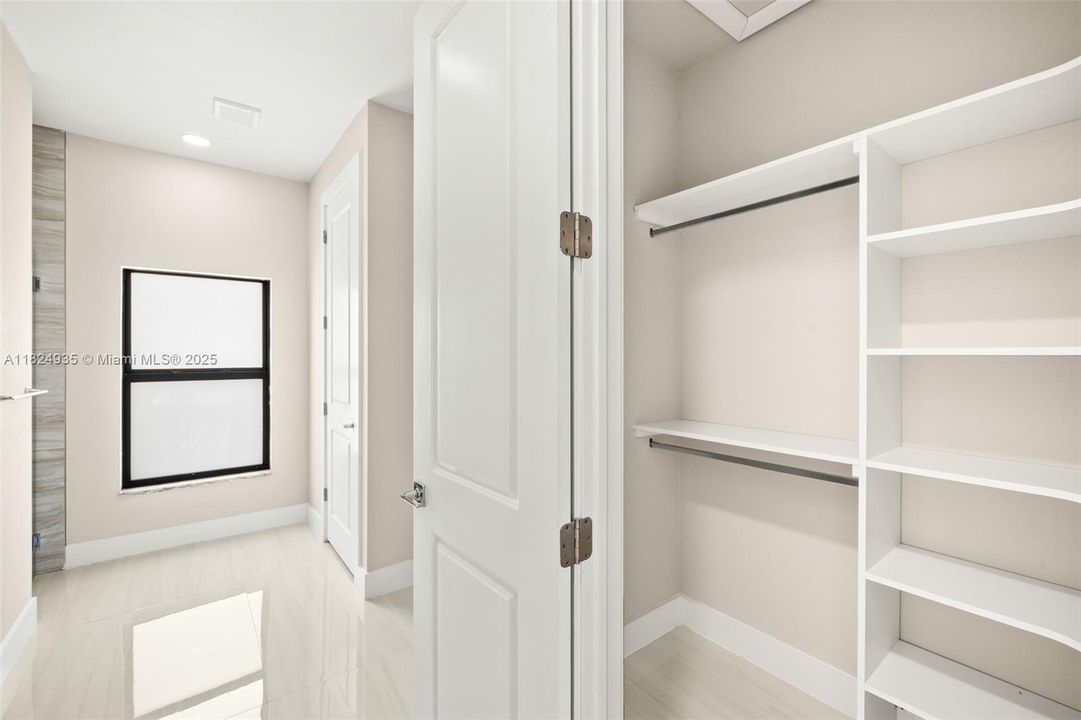 First Primary Walk-In Closet with Built-In Shelving