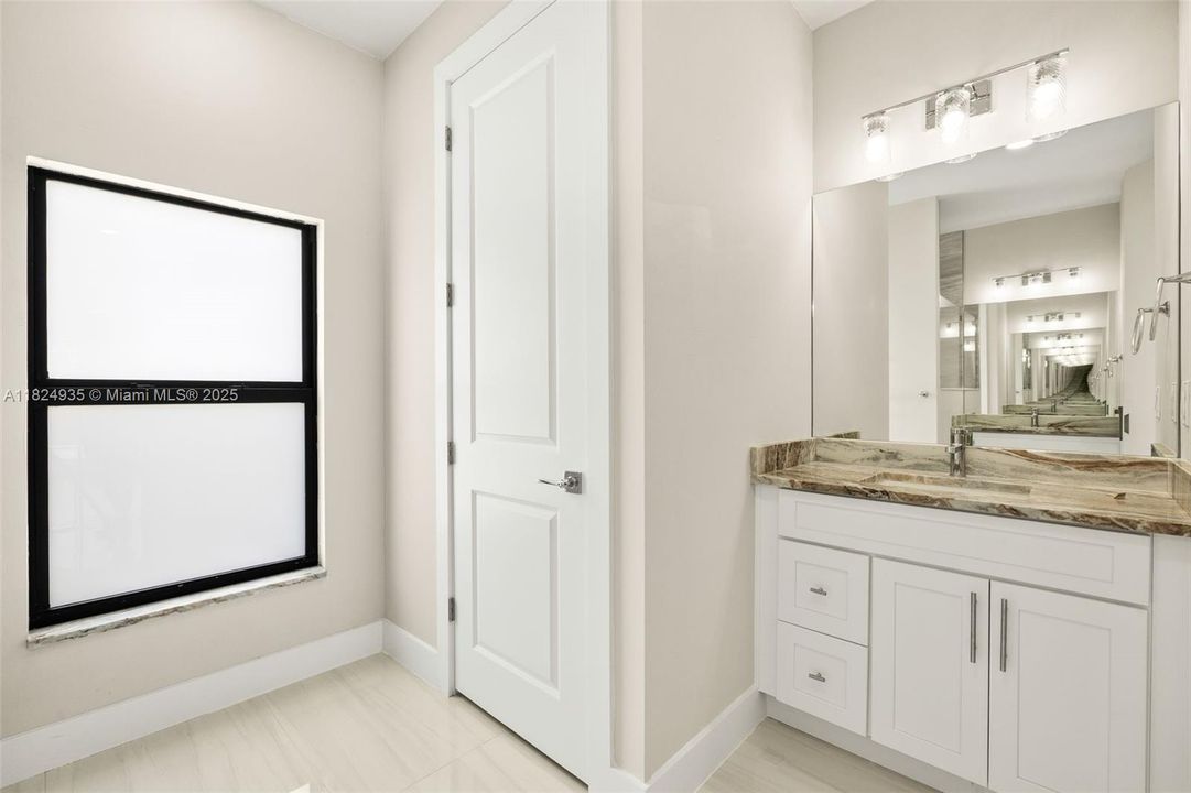 Primary Bathroom - dual sinks with granite countertops, tiled shower