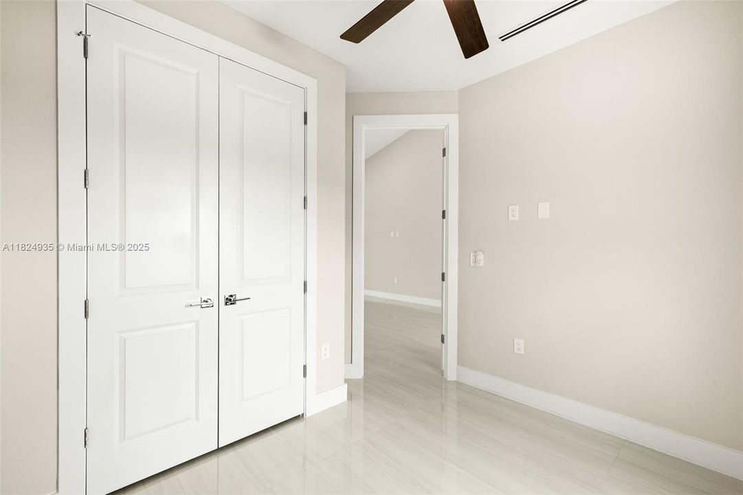 Bedroom 2 closet with built in shelving.