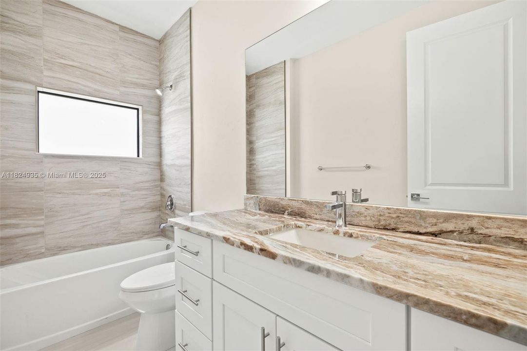 Guest bathroom, granite countertops, tiled shower/tub combo