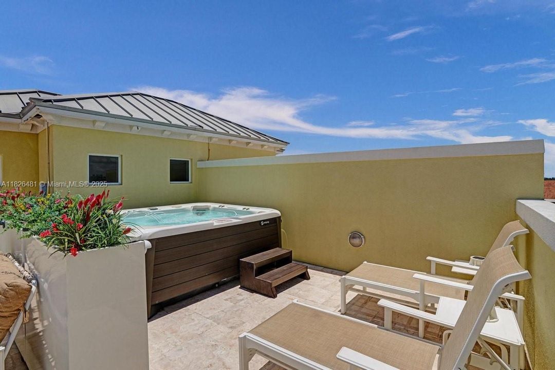 ROOF PATIO WITH SALT WATER SPA.