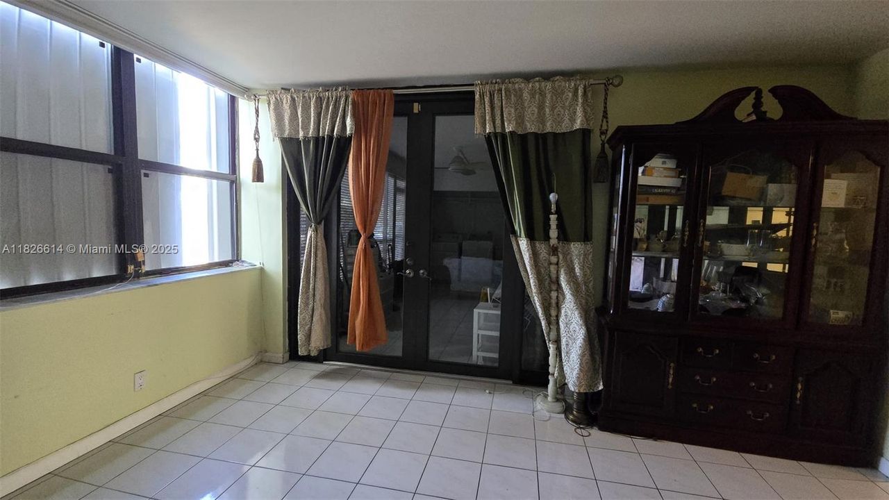 Living room exit to covered family room with Washer/Dryer space