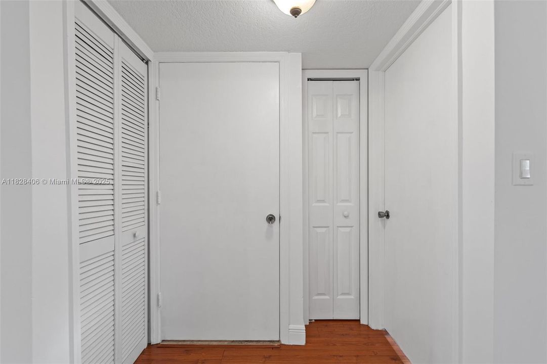 Right door is guest bedroom entrance. Moving left is a storage closet. The door to the left of that is the bathroom door.