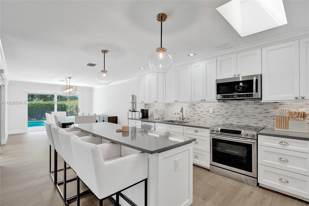 Open-concept kitchen featuring a chef’s island designed for cooking, entertaining, and casual dining.