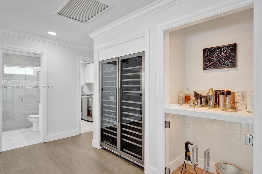 Dual wine fridge and dedicated bar with a mixology station — perfect for entertaining in style.