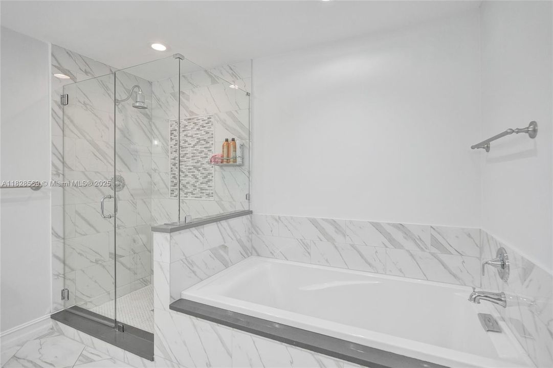 Primary bathroom features dual sinks, a separate shower, and a soaking tub for a spa-like experience.
