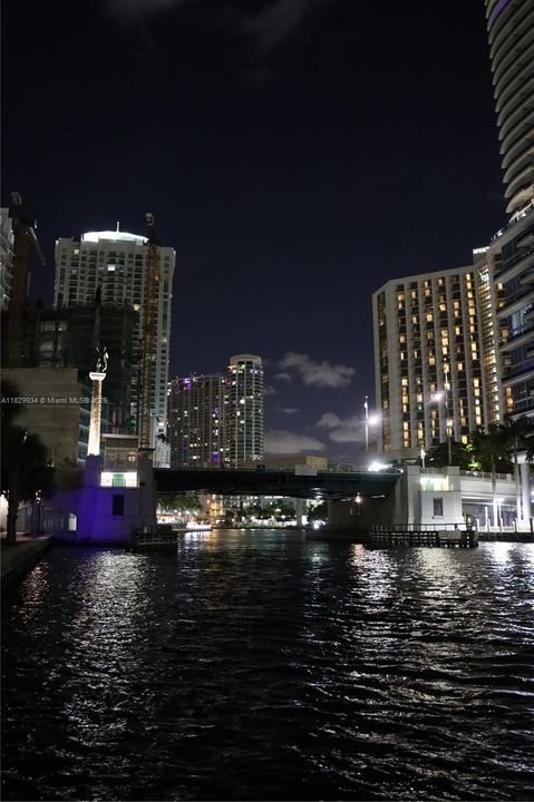 Evening reflections dance along the Miami River — an enchanting nighttime view moments from your doorstep.