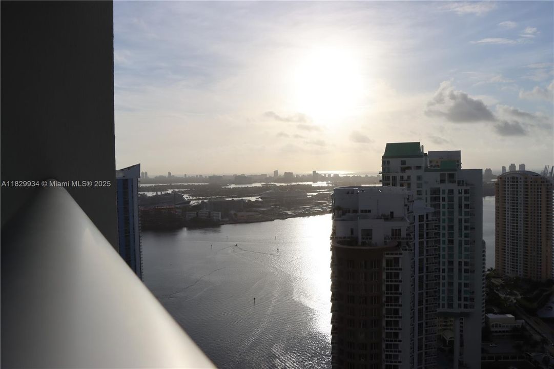 Closer sunrise perspective from the main balcony, capturing the golden reflection across Biscayne Bay and the peaceful start of the day from your private terrace.