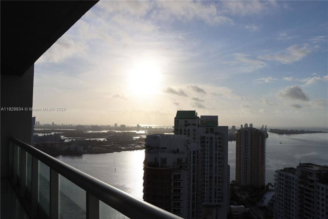 Peaceful early-morning view from the main balcony overlooking Biscayne Bay — watch the sunrise reflect over the water and illuminate Brickell Key.