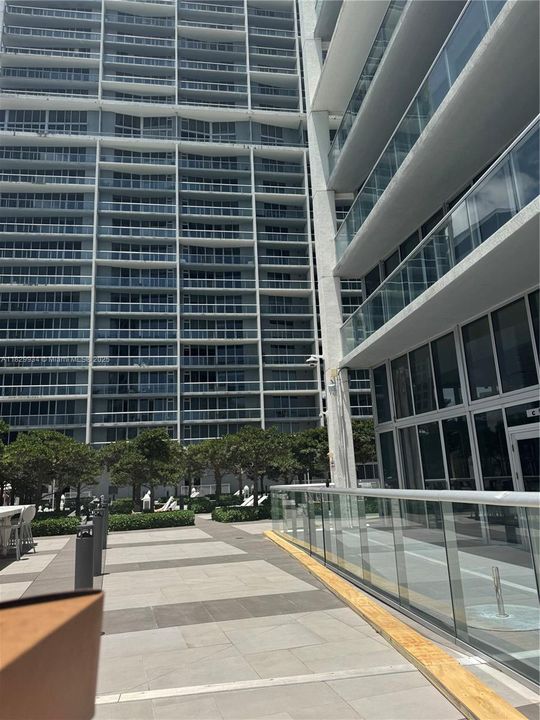 Architectural view of the tower’s modern glass façade and landscaped entry — where contemporary design meets resort-style living.