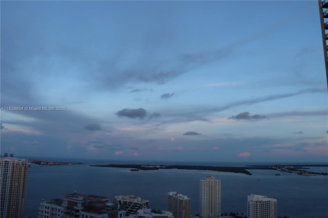 Unobstructed bay views stretch endlessly toward Virginia Key and the horizon — a tranquil backdrop for elevated city living