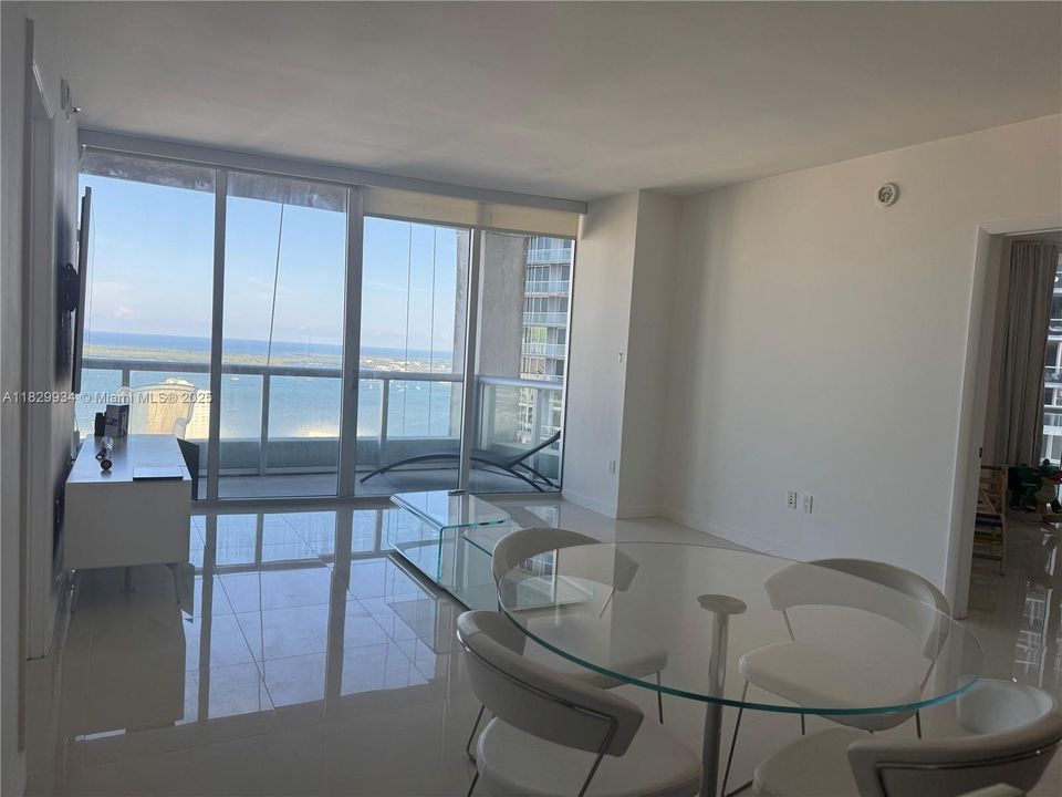 Bright open dining area with expansive bay views, ideal for a stylish dining setup or flexible use of space.
