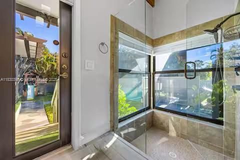 Glass shower sanctuary with tropical garden backdrop!
