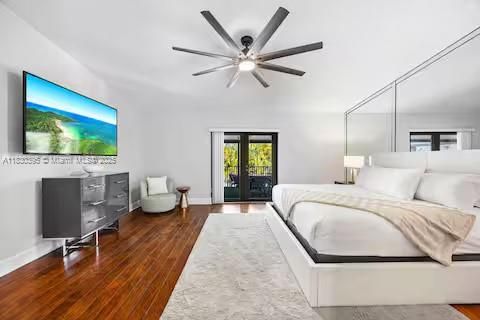 Clean white bedroom sanctuary with French door views!
