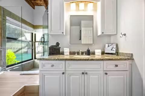 Pristine powder room with granite counters and garden views!