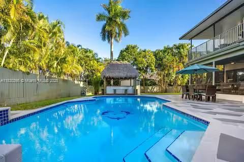 Backyard retreat with tiki hut and sparkling pool!