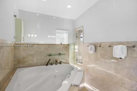 Luxe bathroom with jetted tub and travertine elegance!