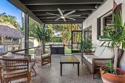 Tropical lanai with rattan furniture and lush plants!