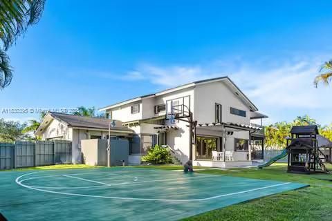 Modern estate with full basketball court and tropical landscaping!