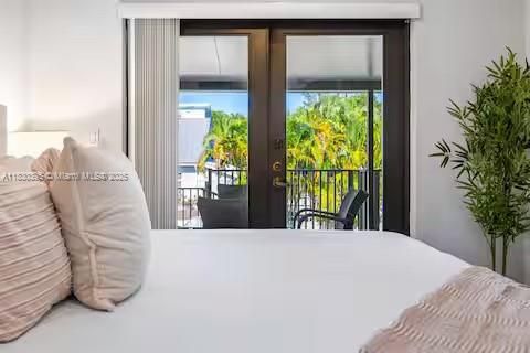 Serene bedroom with French doors to paradise!