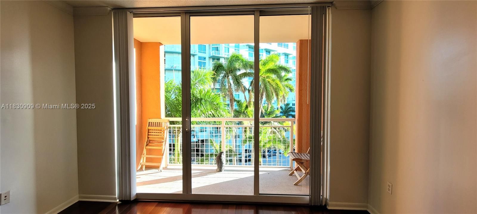 view to private balcony with tropical palm trees in front