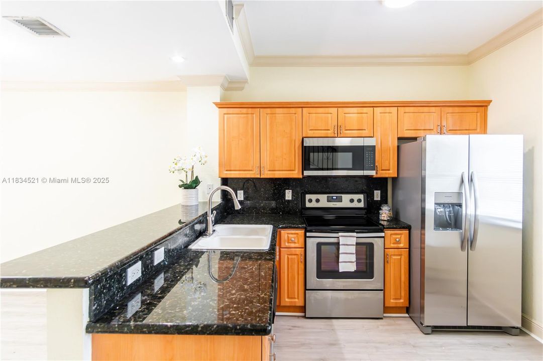 Sharp, modern kitchen with stainless steel appliances.